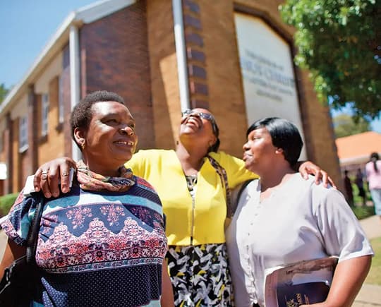 Latter-day Saint families and neighbors gathered outside their local chapel